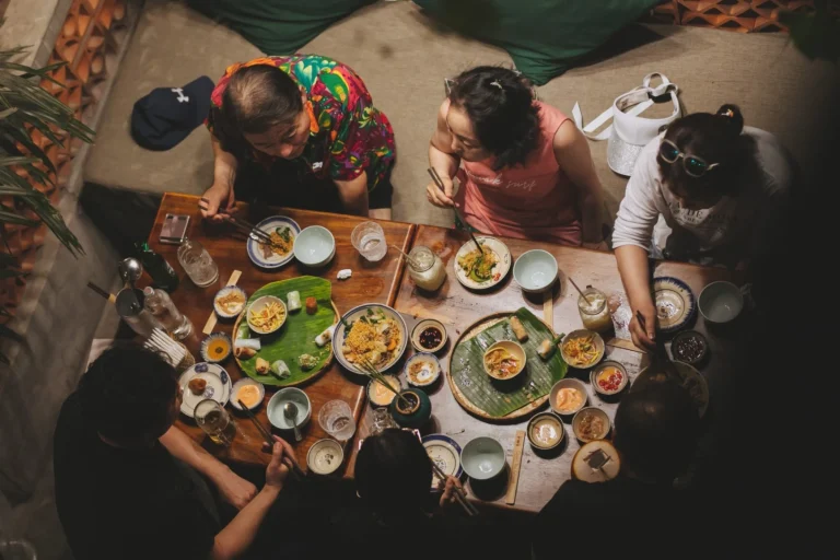 Góc trang trí bình hoa sen thanh tịnh bên cạnh ô cửa kính màu tròn tại nhà hàng Quán Bụi Garden