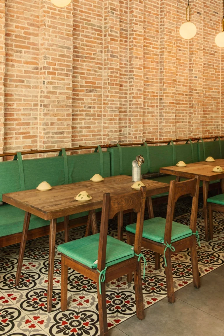 Góc trang trí nghệ thuật cổ điển với tranh treo tường và bình gốm truyền thống tại nhà hàng Quán Bụi Express